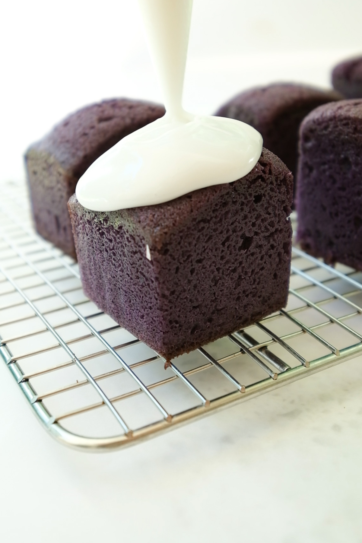 pipe on coconut glaze on ube pound cake