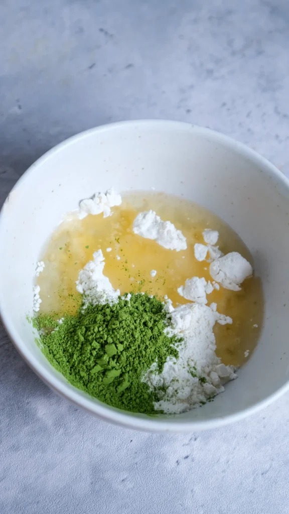 Matcha cake flour, match and oil in bowl 