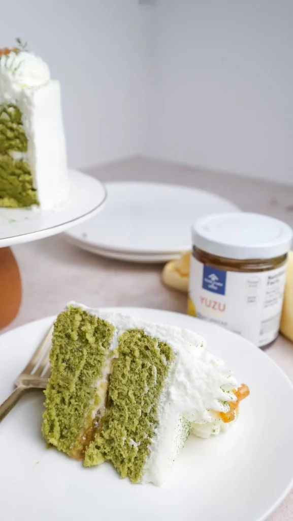 Matcha cake slice with yuzu jam in the back 