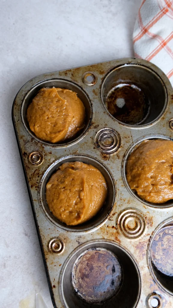 Pumpkin cream cheese muffins cream cheese scooped into muffin tin 