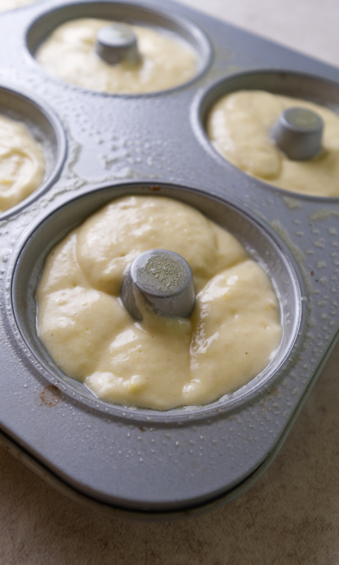 lemon batter piped into bundt cake