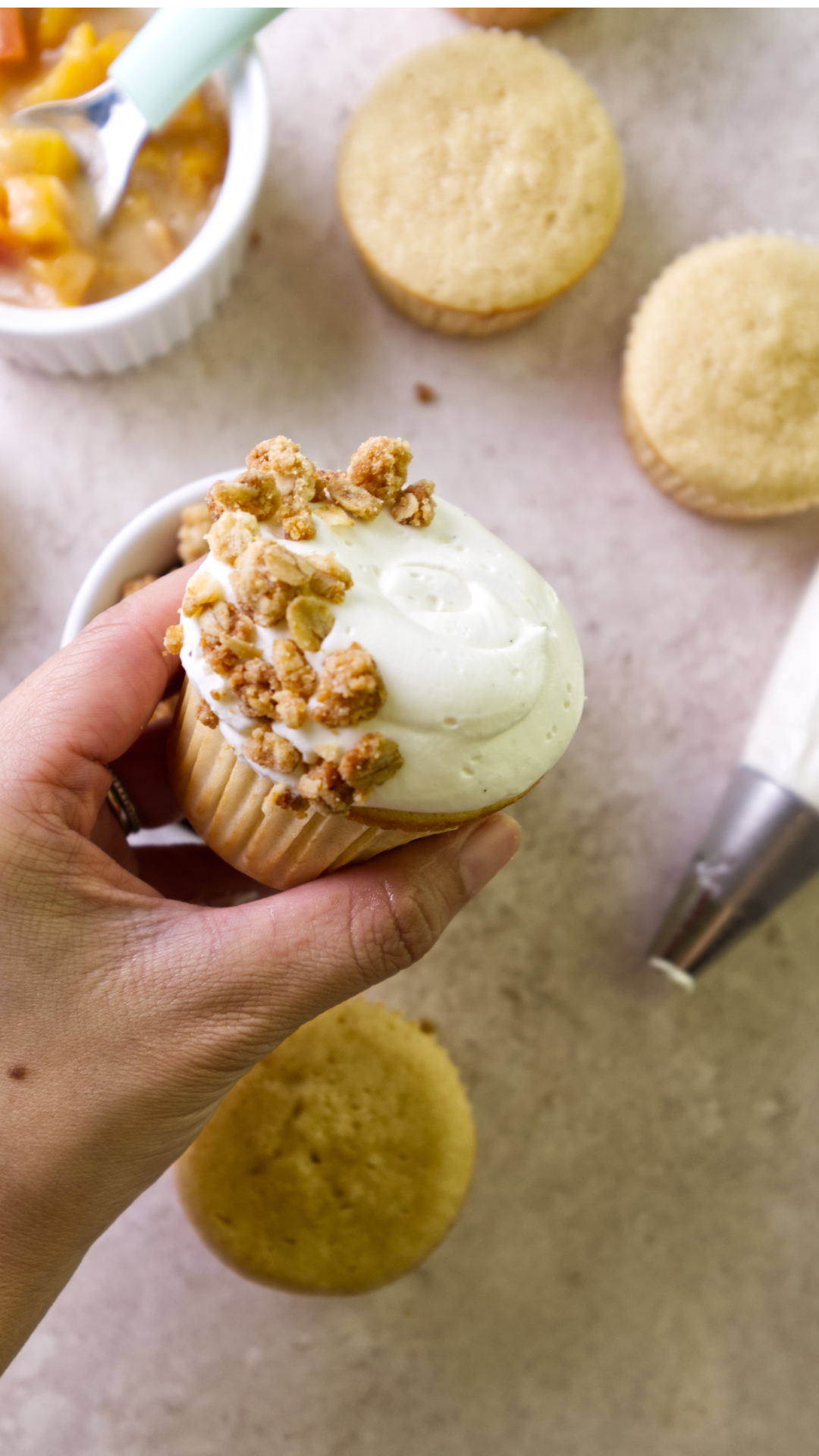 peach cupcakes with frosting and streusel