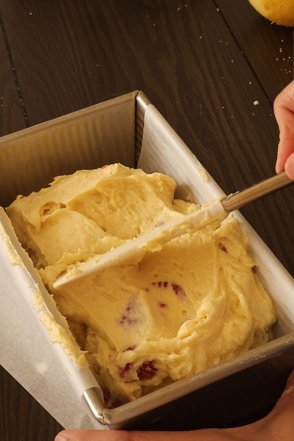 place raspberry lemon loaf batter into loaf pan 