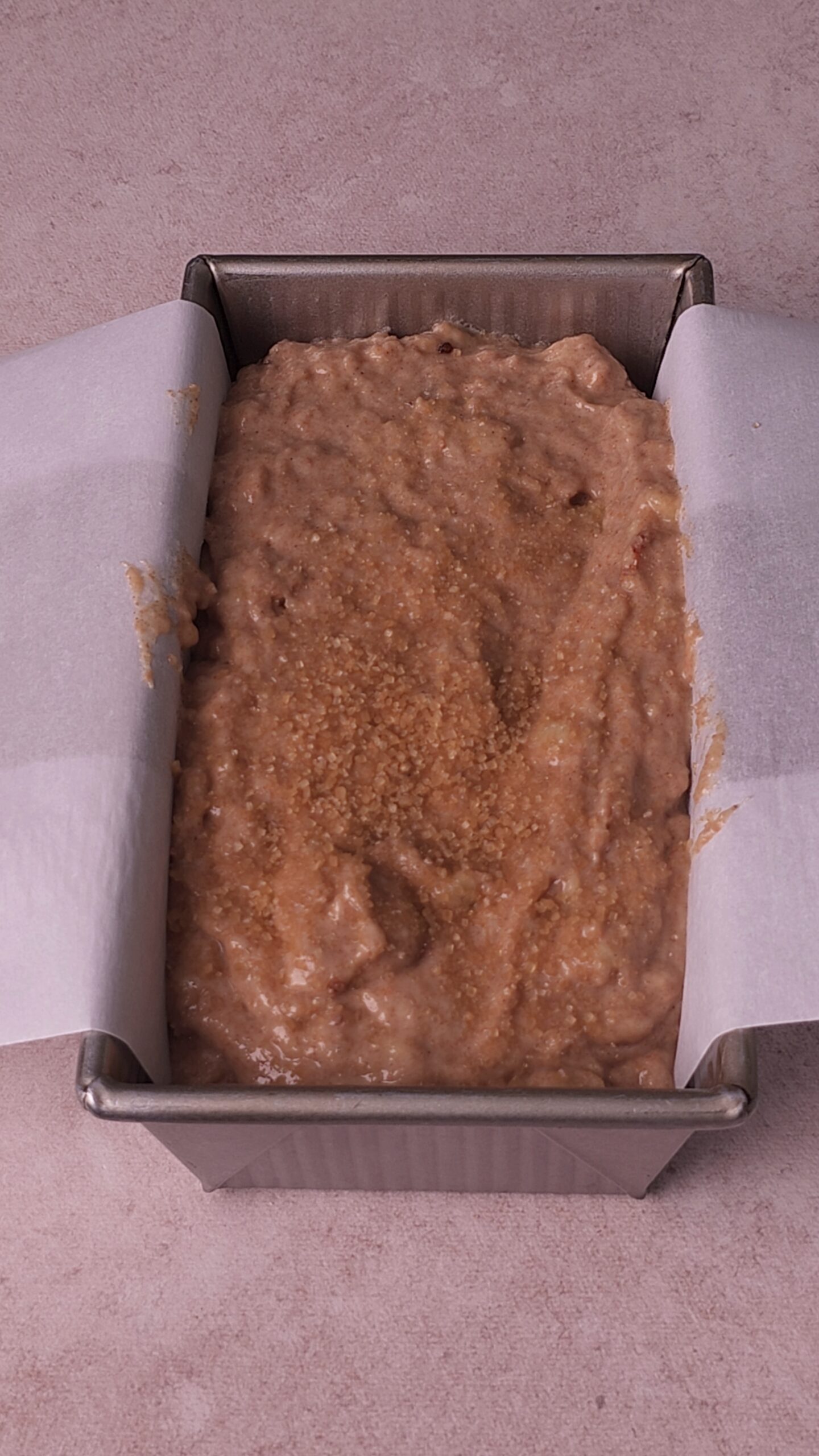 Whole Wheat Banana bread batter in loaf pan with parchment paper
