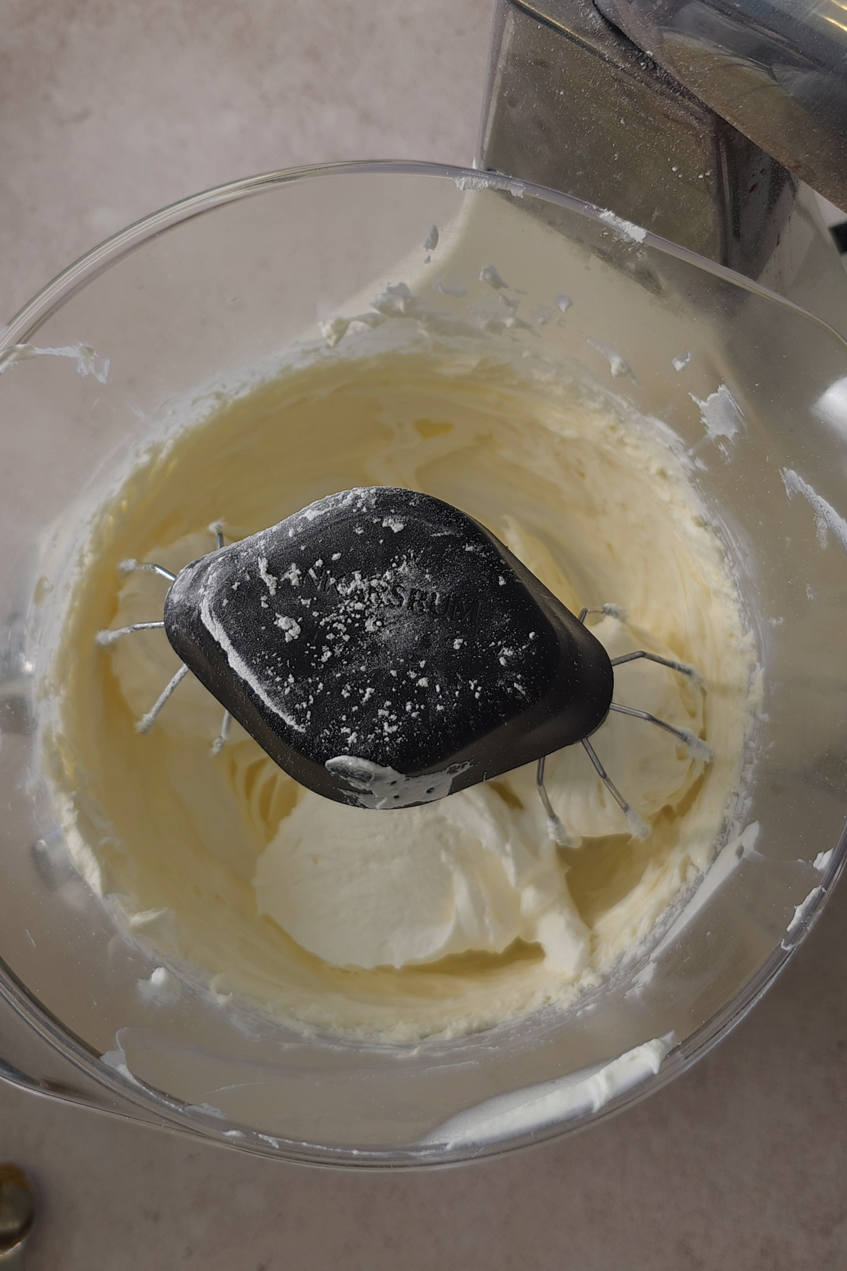cream cheese in mixing bowl with whipped cream 