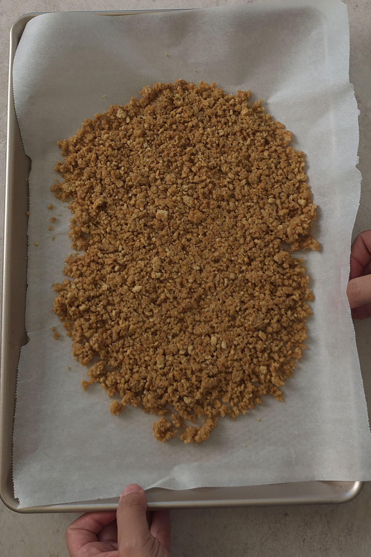 graham cracker crumble on tray to be baked 