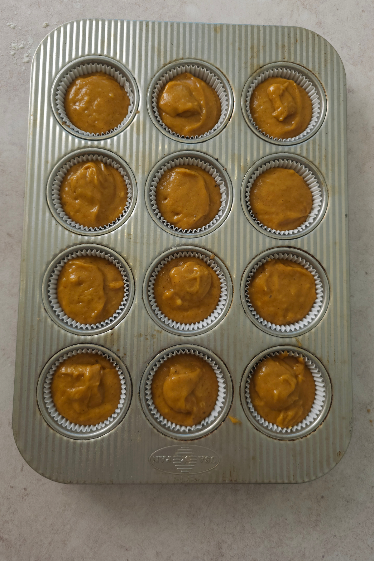 pumpkin cupcakes in baking tin 