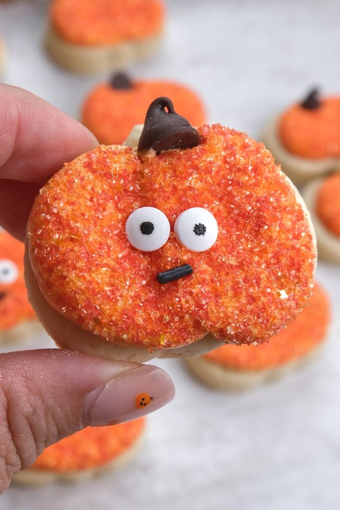 cream cheese sugar cookies-decorated into Halloween pumpkin with sprinkles and eyes