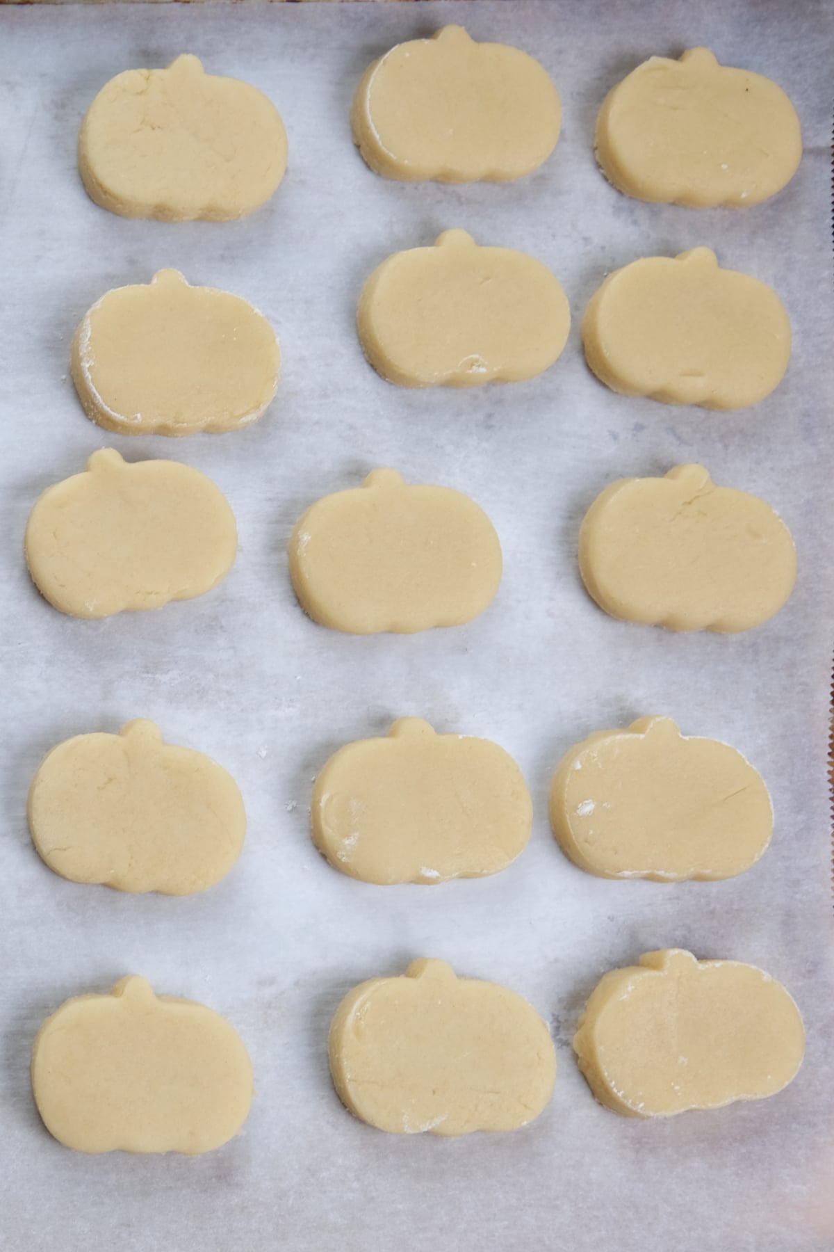 cut out cream cheese sugar cookies into mini pumpkins