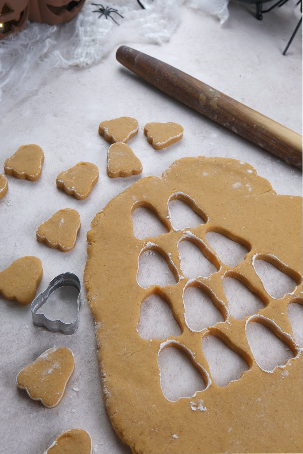 pumpkin sugar cookei dough rolled out into ghost