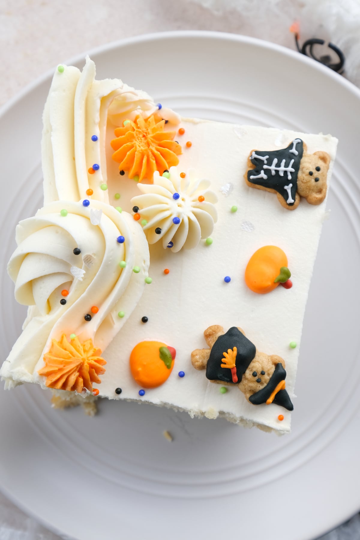 a slice of halloween vanilla sheet cake on a small plate